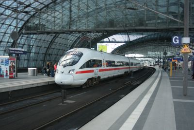 BD ICE-TD no: 605-003 at Berlin Hauptbahnhof on 13th April 2014 – Steve Ollive A modern German streamlined passenger train stands at a curving platform under the arched glass overall roof of a major station.